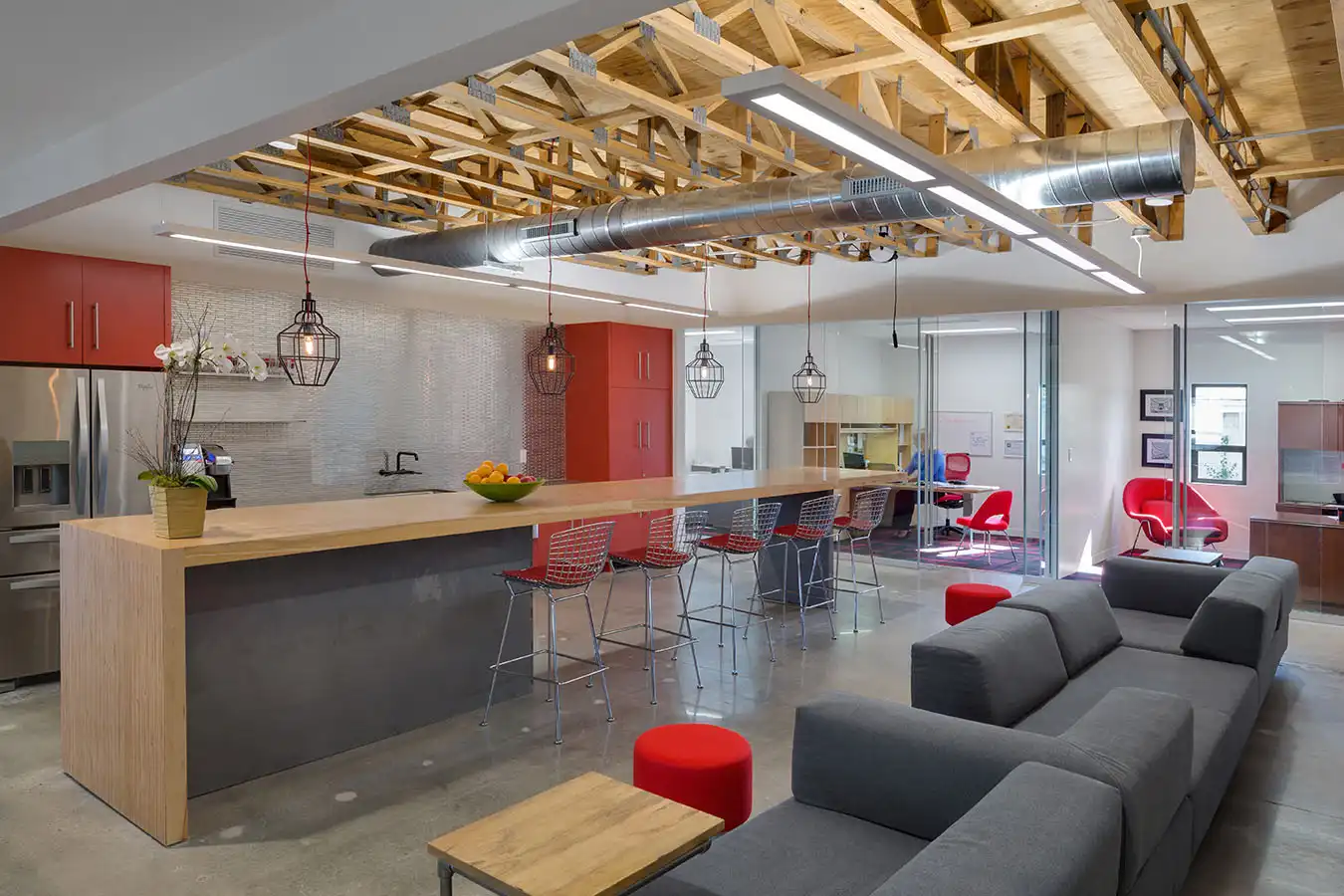 An office kitchen with couch and bar seating
