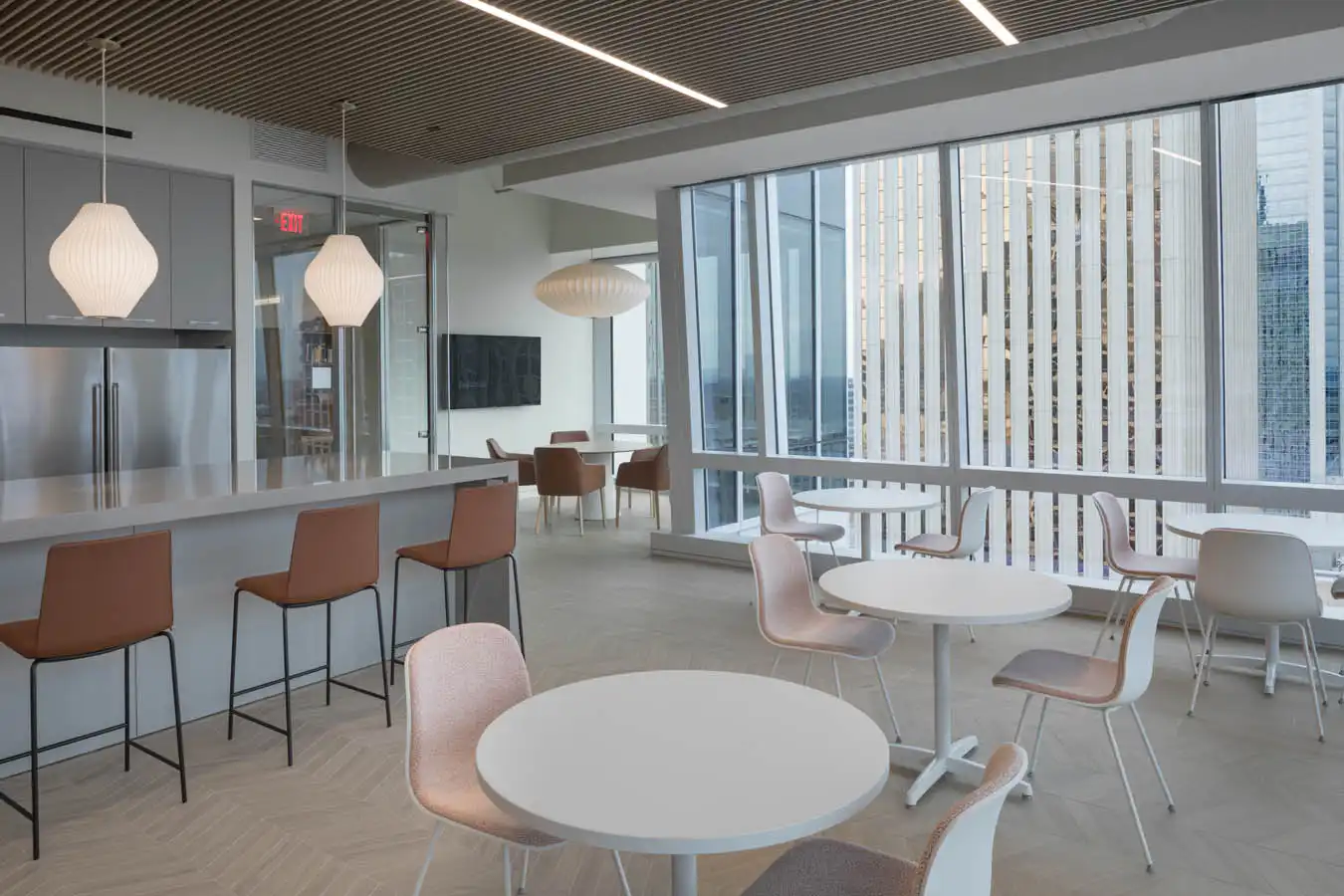 Office lounge in a high rise with table and bar seating