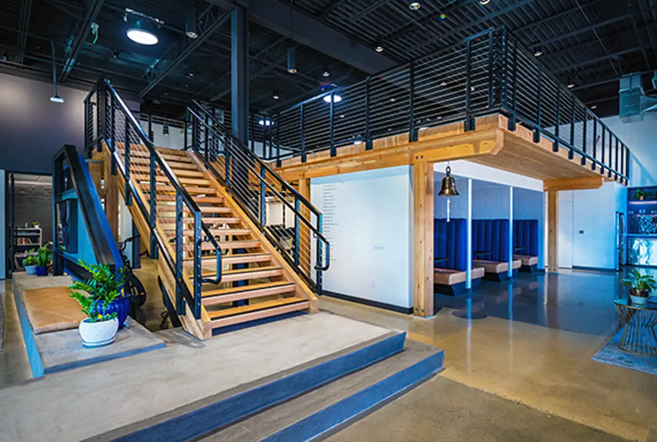 Swinerton lobby with booth seating and stairs leading to offices