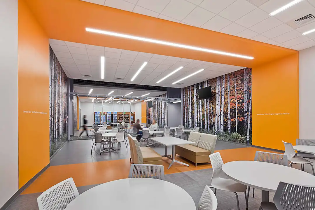 Cafe with seating, TVs on the walls, and vending machines in the back